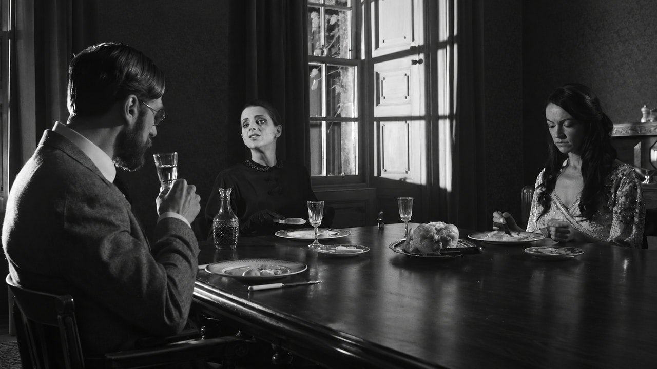 Three characters at a dining table in the monochrome world of The Black Gloves